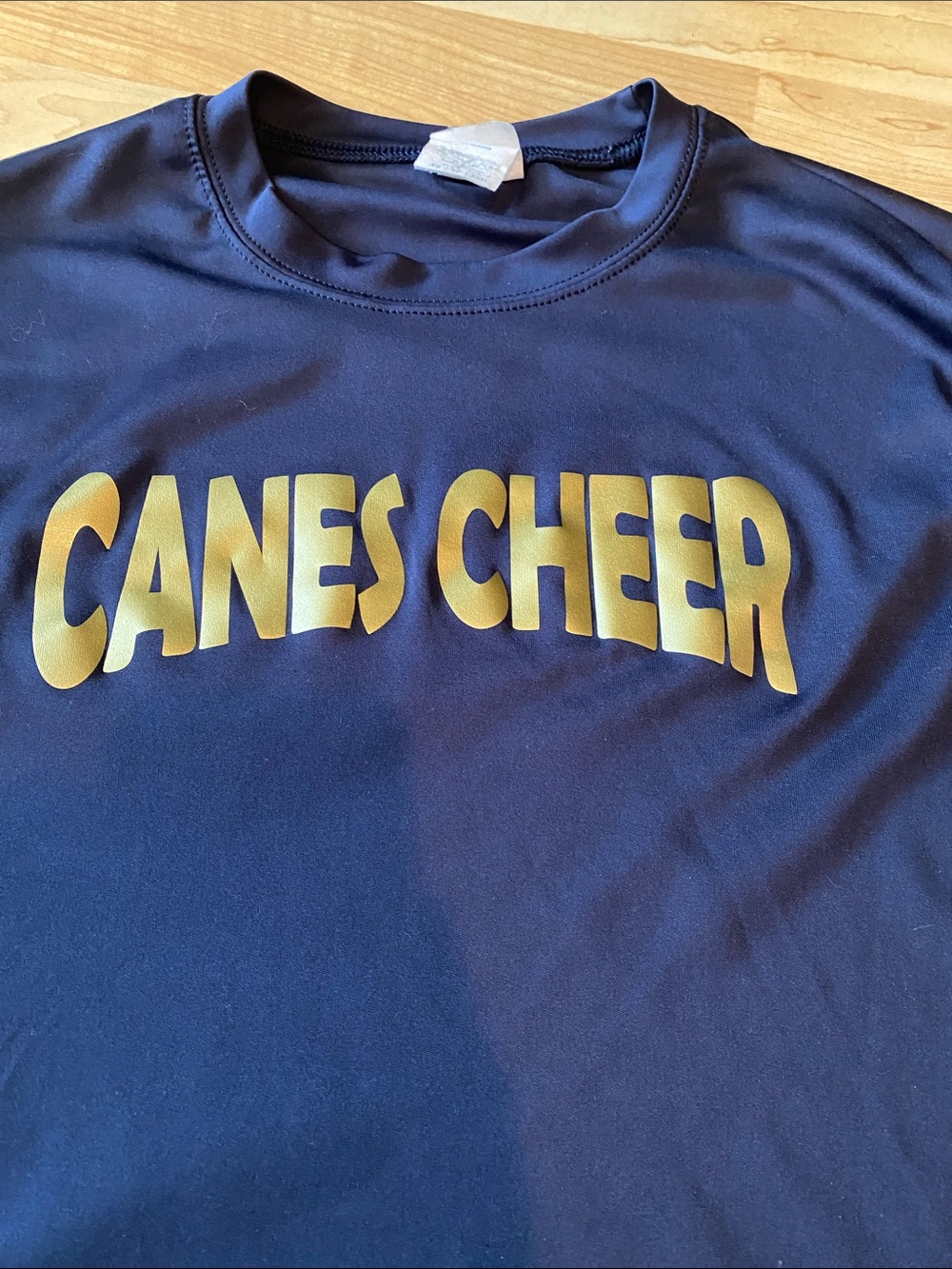 Canes Cheer Navy Blue Performance Shirt with Gold Lettering